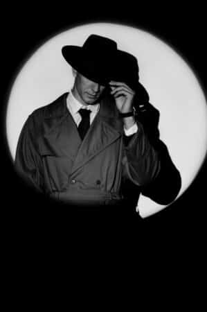 A,dark,silhouette,of,a,male,detective,in,a,coat