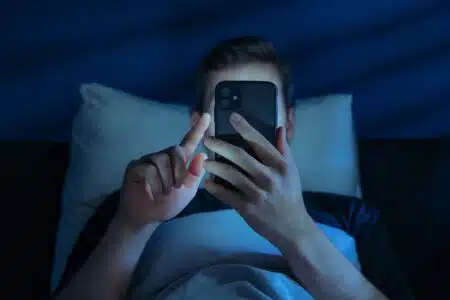 Close,up,of,young,man,,alone,in,the,dark,bedroom,