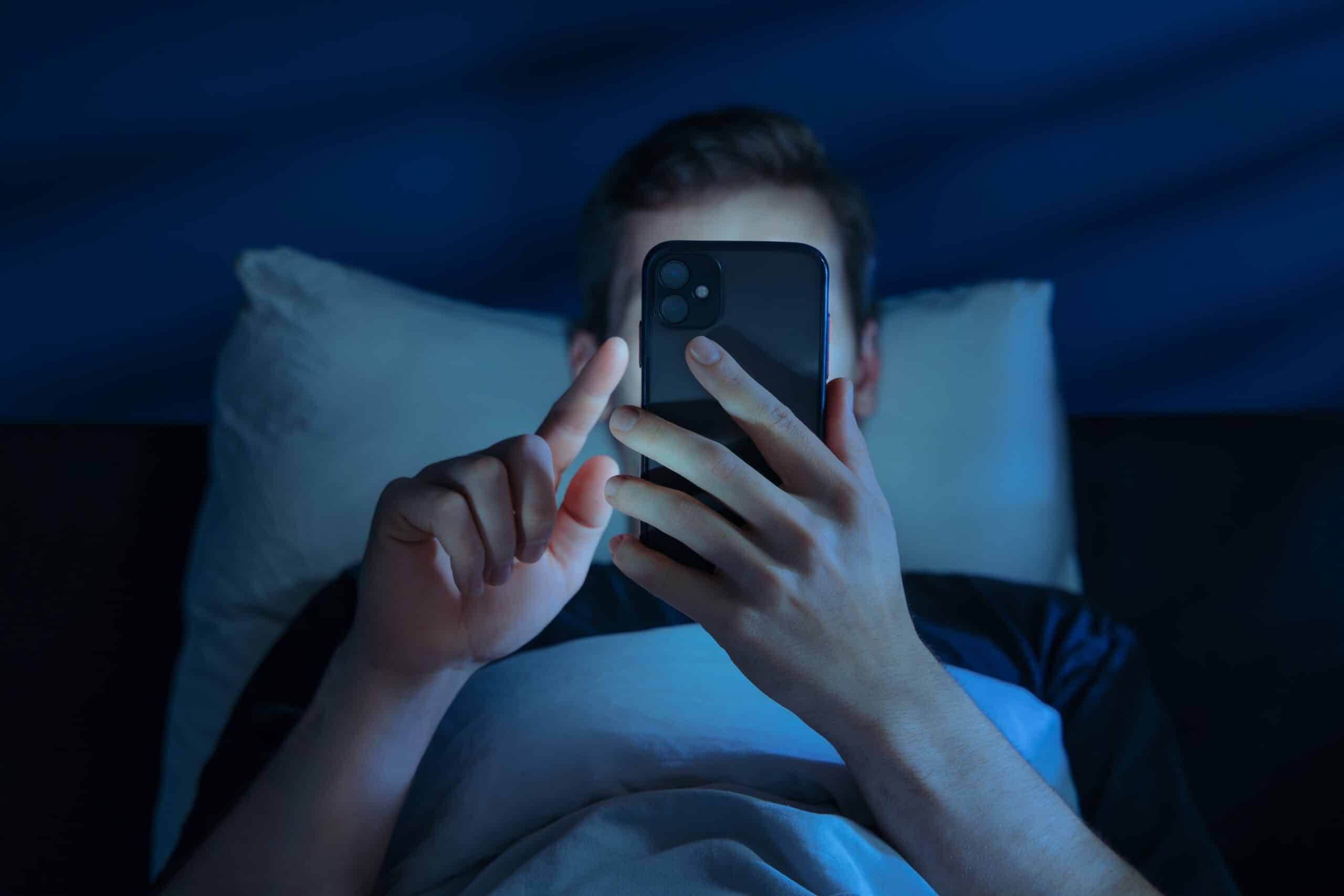 Close,up,of,young,man,,alone,in,the,dark,bedroom,