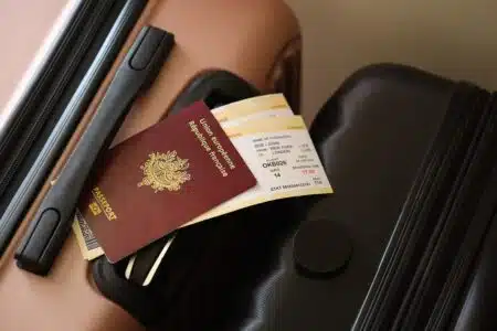 French,passport,with,tickets,lies,on,touristic,suitcase,close,up